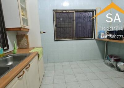 Spacious kitchen with dual sinks and tiled flooring