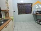 Spacious kitchen with dual sinks and tiled flooring