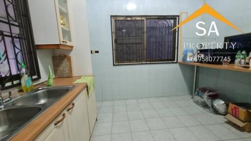 Spacious kitchen with dual sinks and tiled flooring