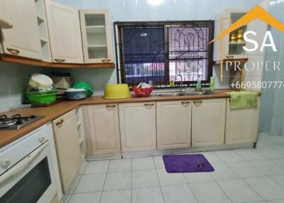 Spacious kitchen with wooden cabinets and modern appliances