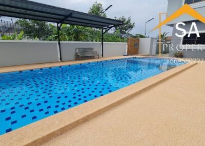 Outdoor pool next to a building