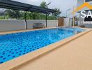 Outdoor pool next to a building