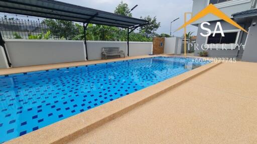 Outdoor pool next to a building