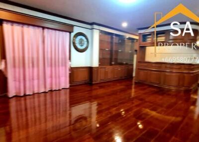 Spacious living room with wooden flooring and built-in cabinets