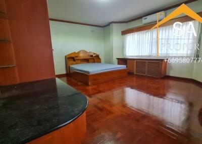 Bedroom with wooden furniture and flooring