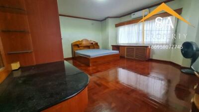 Bedroom with wooden furniture and flooring