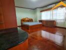 Bedroom with wooden furniture and flooring