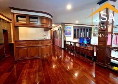 Spacious and elegant living area with wooden floor and built-in cabinetry