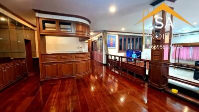 Spacious and elegant living area with wooden floor and built-in cabinetry