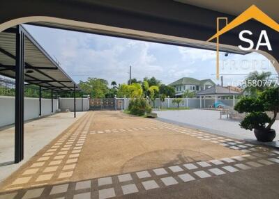 spacious outdoor area with covered parking and manicured landscape