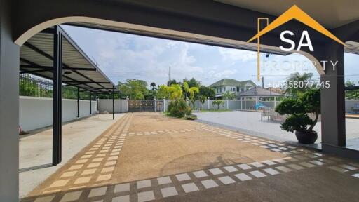 spacious outdoor area with covered parking and manicured landscape