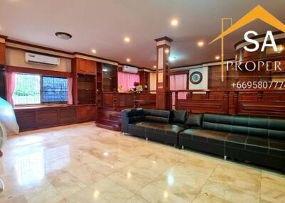 Spacious living room with wooden accents and marble flooring