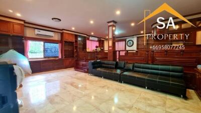 Spacious living room with wooden accents and marble flooring