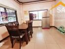 Kitchen with dining table and refrigerator