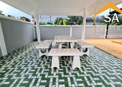 Covered outdoor seating area with tile flooring