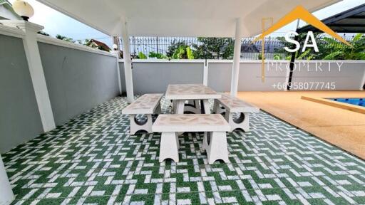 Covered outdoor seating area with tile flooring