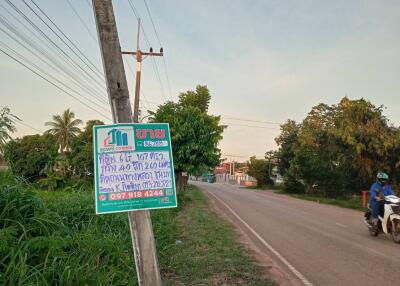 Roadside view with a signpost and a motorcyclist