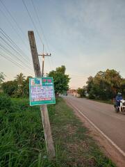 Roadside view with a signpost and a motorcyclist