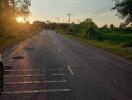 Sunset view with a road and surrounding greenery