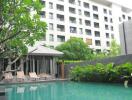 Condominium pool area with lounges and greenery