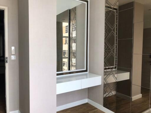 Bedroom with mirrored closet and floating vanity