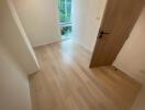 Bedroom with wooden flooring and a window