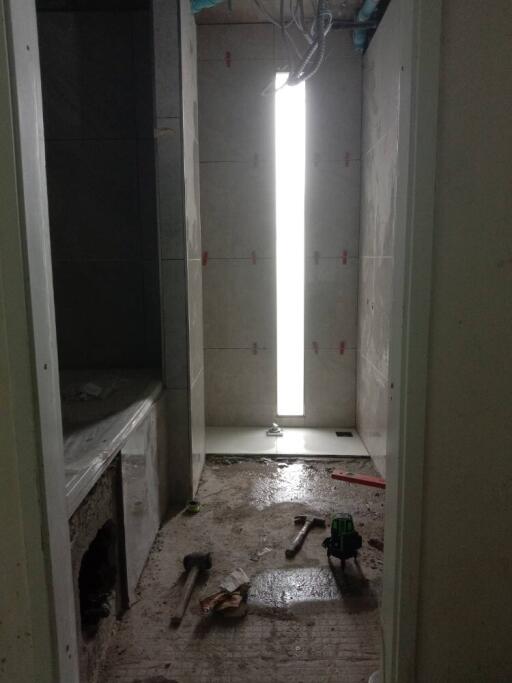 Under construction bathroom with tools on the floor