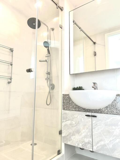 Modern bathroom with a glass-enclosed shower and a stylish sink