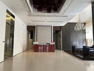 Modern lobby with chandelier and reception desk