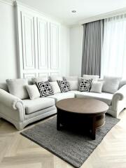 Modern living room with gray sectional sofa, wooden coffee table, and decorative pillows