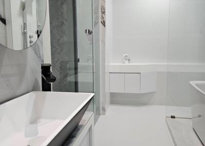 Modern bathroom with sink, mirror, shower, and bathtub