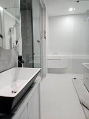 Modern bathroom with sink, mirror, shower, and bathtub