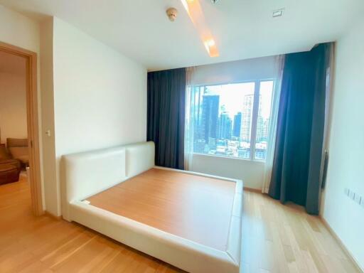 Spacious bedroom with large window and city view