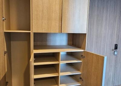 Built-in storage area with wooden cabinets and open shelves