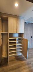 Built-in storage area with wooden cabinets and open shelves