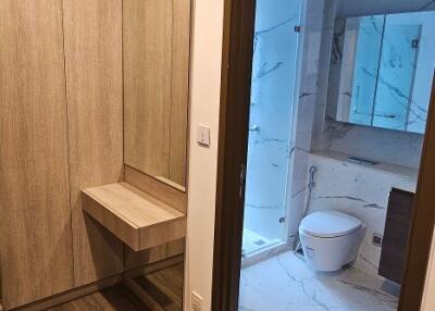 Modern bathroom with wooden flooring and marble tiling