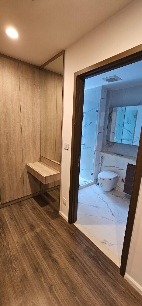 Modern bathroom with wooden flooring and marble tiling