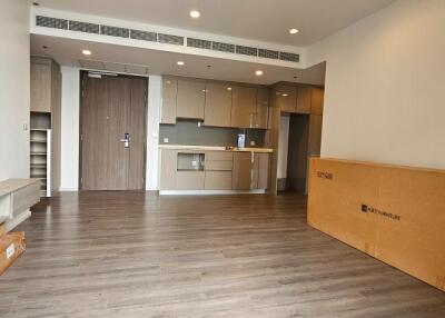 Modern living room with open kitchen and wooden flooring