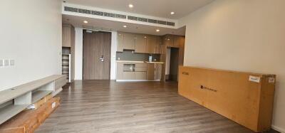 Modern living room with open kitchen and wooden flooring