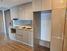 Modern kitchen with integrated appliances and wooden flooring