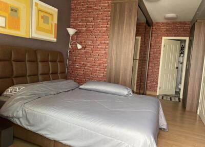 Modern bedroom with brick accent wall