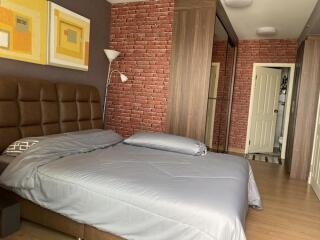 Modern bedroom with brick accent wall