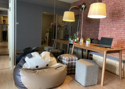 Cozy living room with bean bag, seating, and workspace