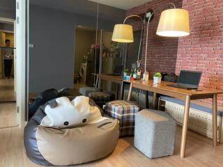 Cozy living room with bean bag, seating, and workspace