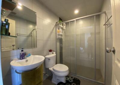 Modern bathroom with glass shower and tile walls