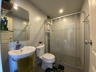 Modern bathroom with glass shower and tile walls