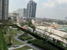 View from the building showcasing landscaped gardens, nearby structures, and transport links