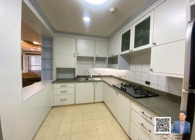 Modern kitchen with white cabinetry and tile flooring