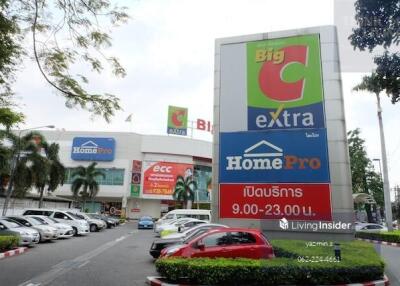 Exterior view of a commercial complex with parking lot and multiple stores including Big C Extra and HomePro