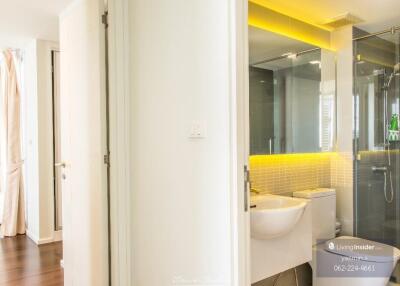 Modern bathroom with glass shower and illuminated mirror